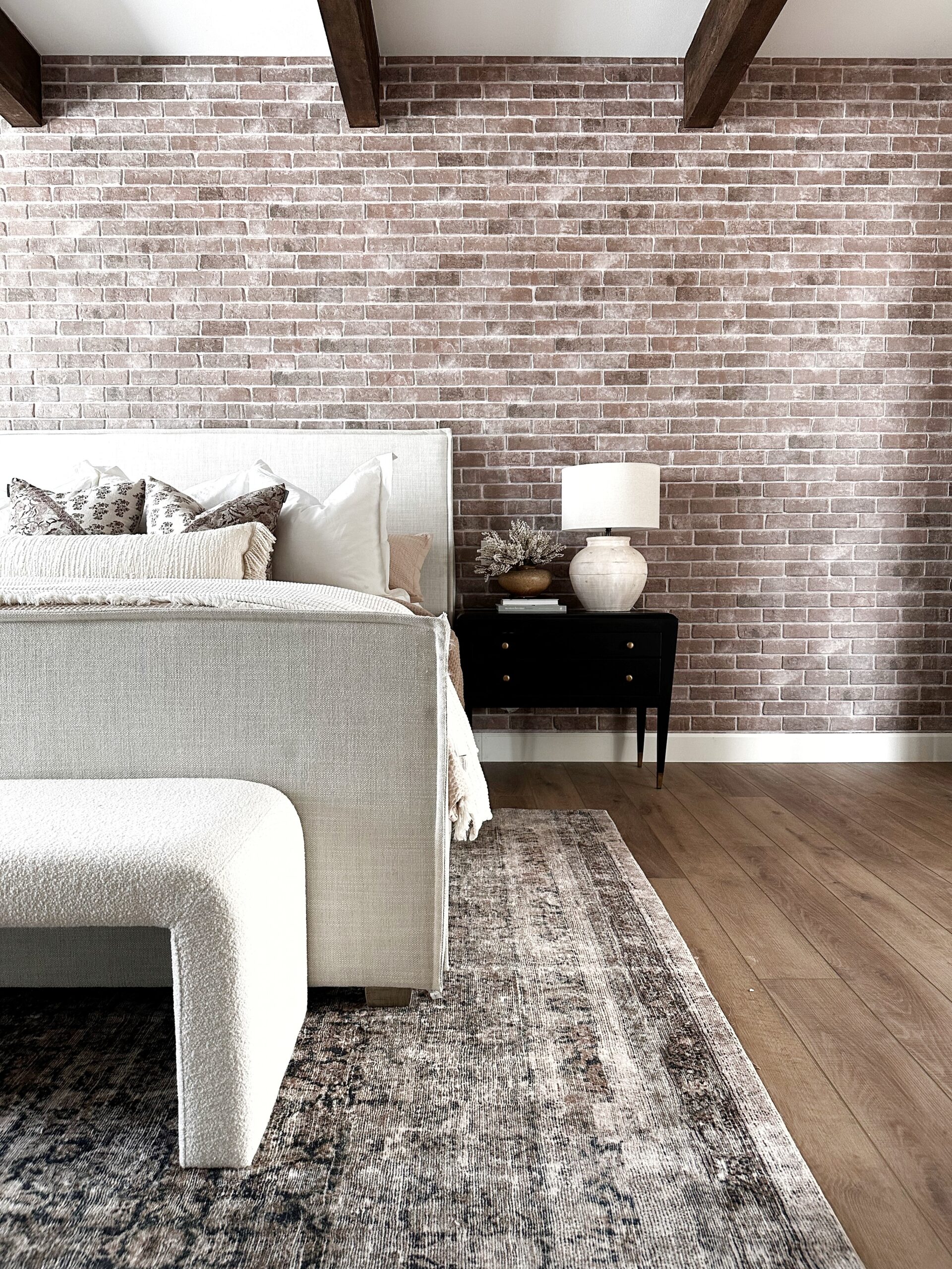 exposed brick wall, bedding, side table, modern bedroom, throw pillows, euro pillows, area rug, master bedroom, home decor, home design 