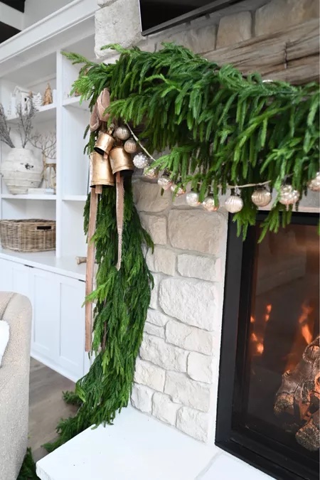 new holiday must haves | #new #holiday #musthaves #christmas #holidaydecor #seasonal #garland #cowbell #gold #ribbon #fireplace #mantle #bells #livingroom #holidaydecor