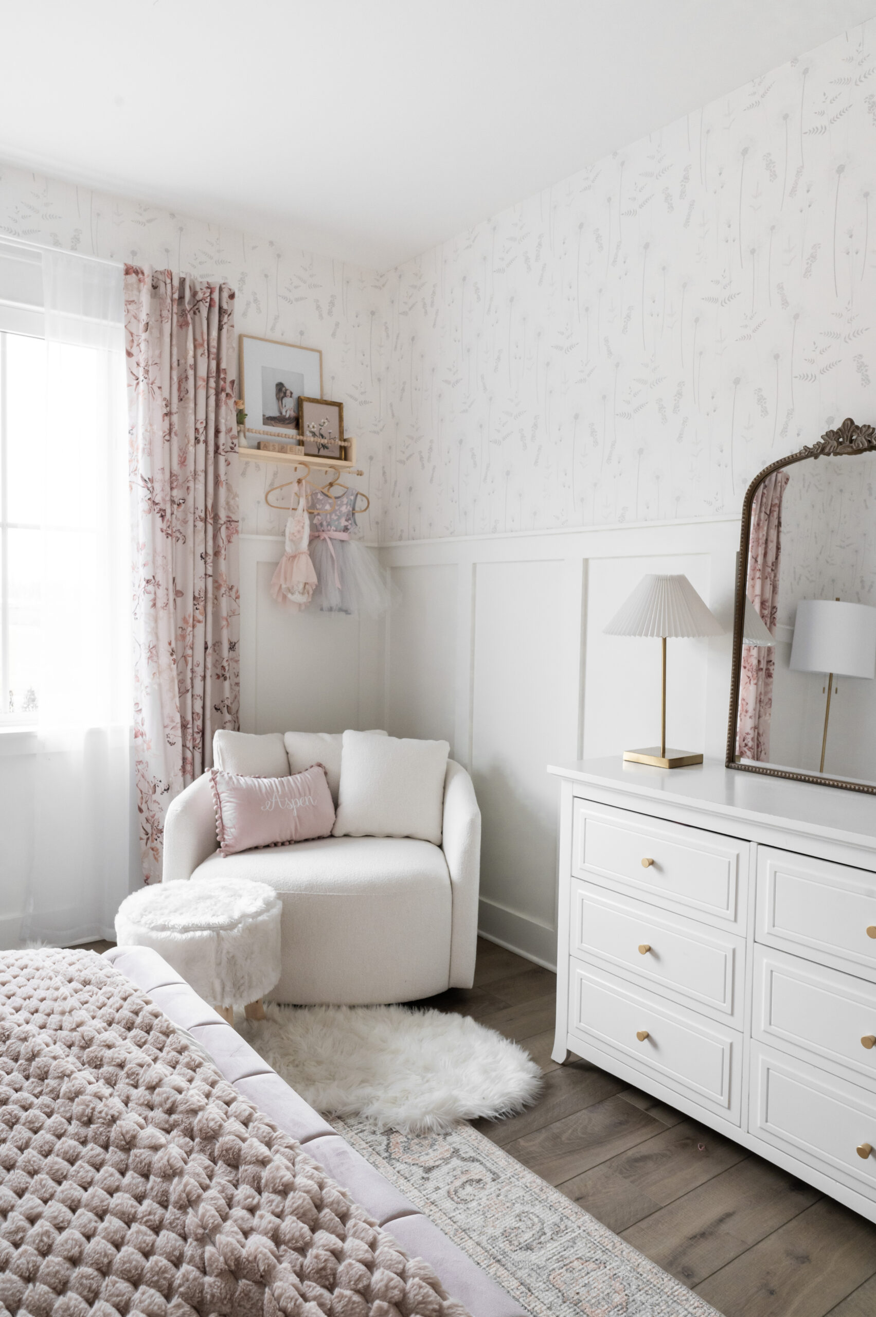 aspens room refresh pretty and pink | bedroom, room refresh, toddlers room, bed frame, accent chair, drapes, curtains, mirror, dresser, blanket, reading nook, shelf, hangers