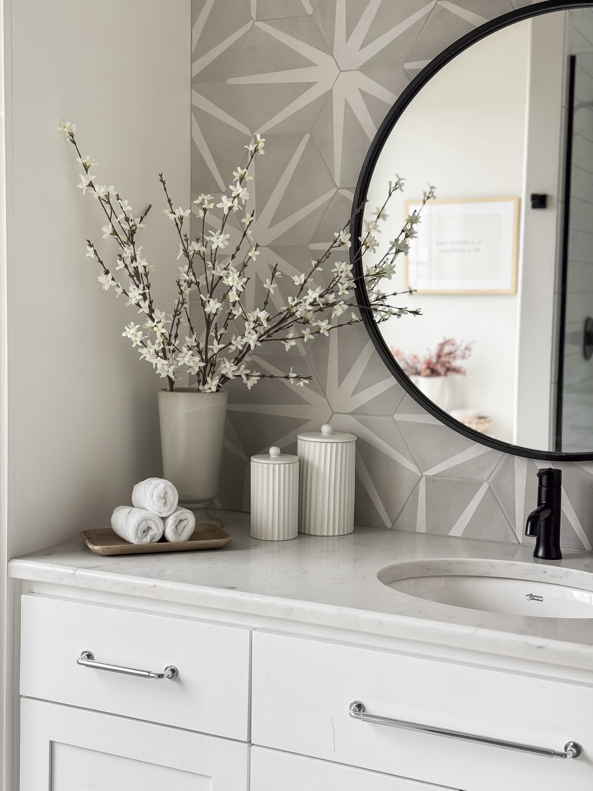 brighten up your home with spring stems | home, home decor, spring, spring stems, spring decor, spring home decor, neutral, wall mirror, canisters, white, wooden, accent wall, blossom branch