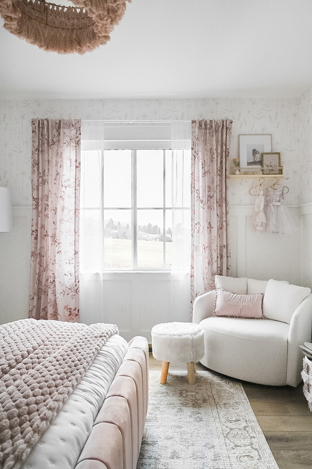 affordable home decor, girl's bedroom styling, girl's bedroom decor, bedroom, swivel chair, area rug, floral drapes, chunky knit blanket