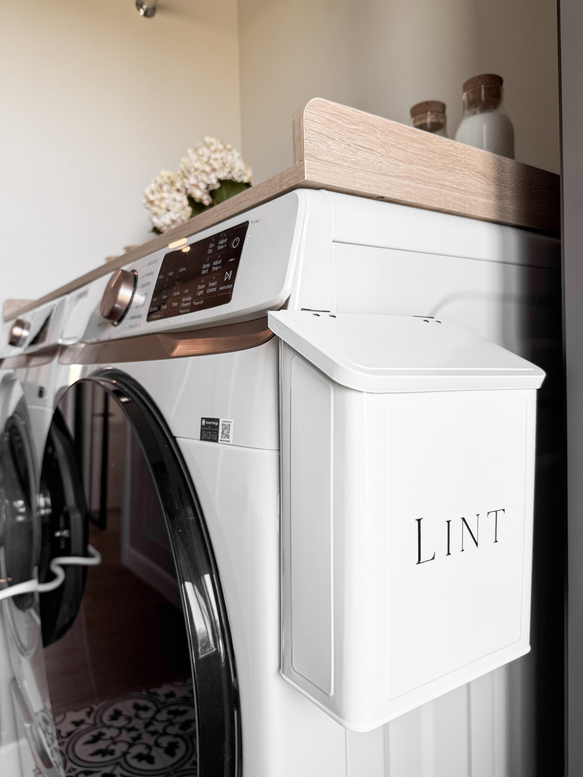 photo of a laundry room featuring a magnetic best sellers lint box and wooden countertop