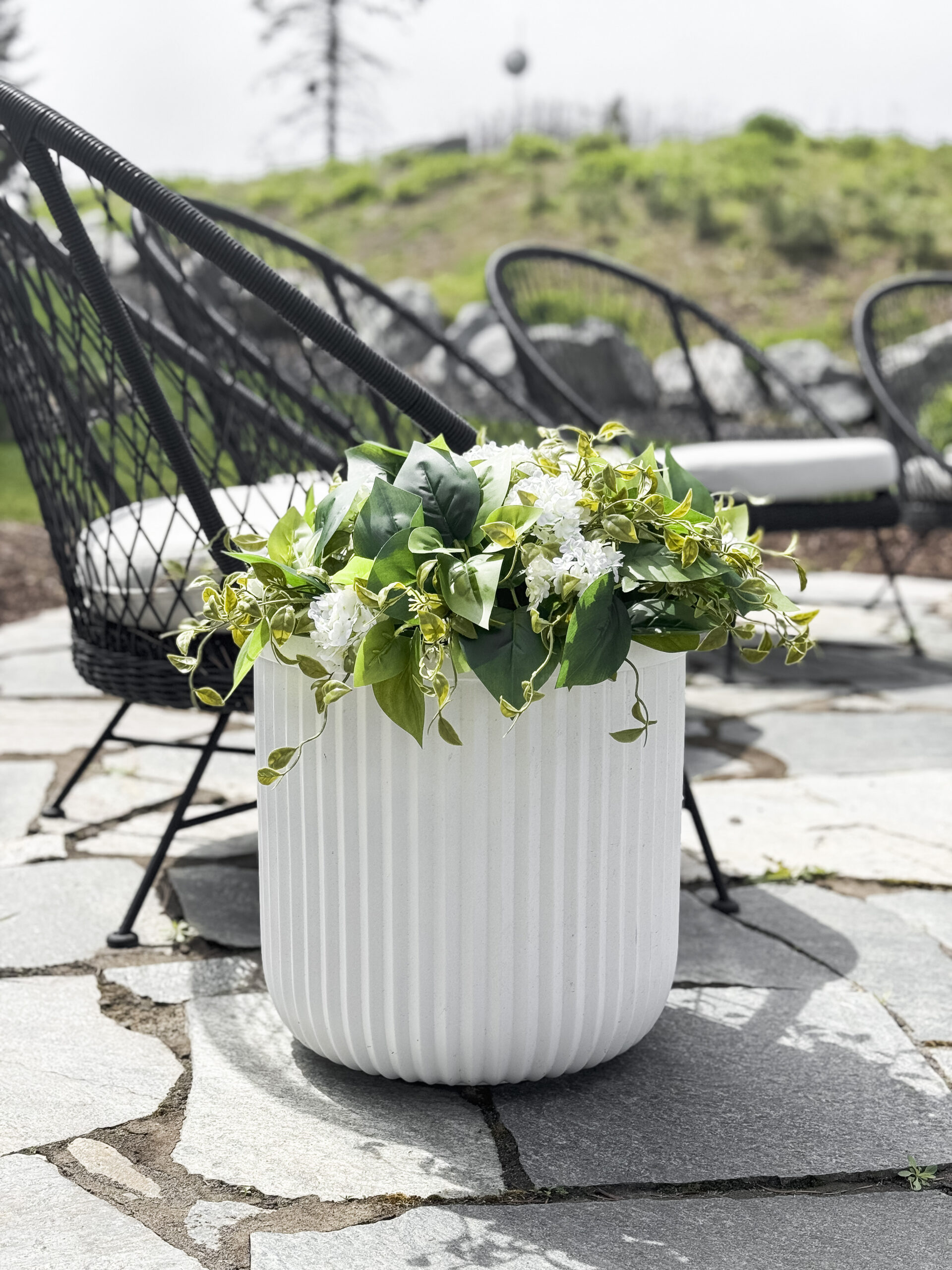 viral white planter with faux florals and greenery for outdoors