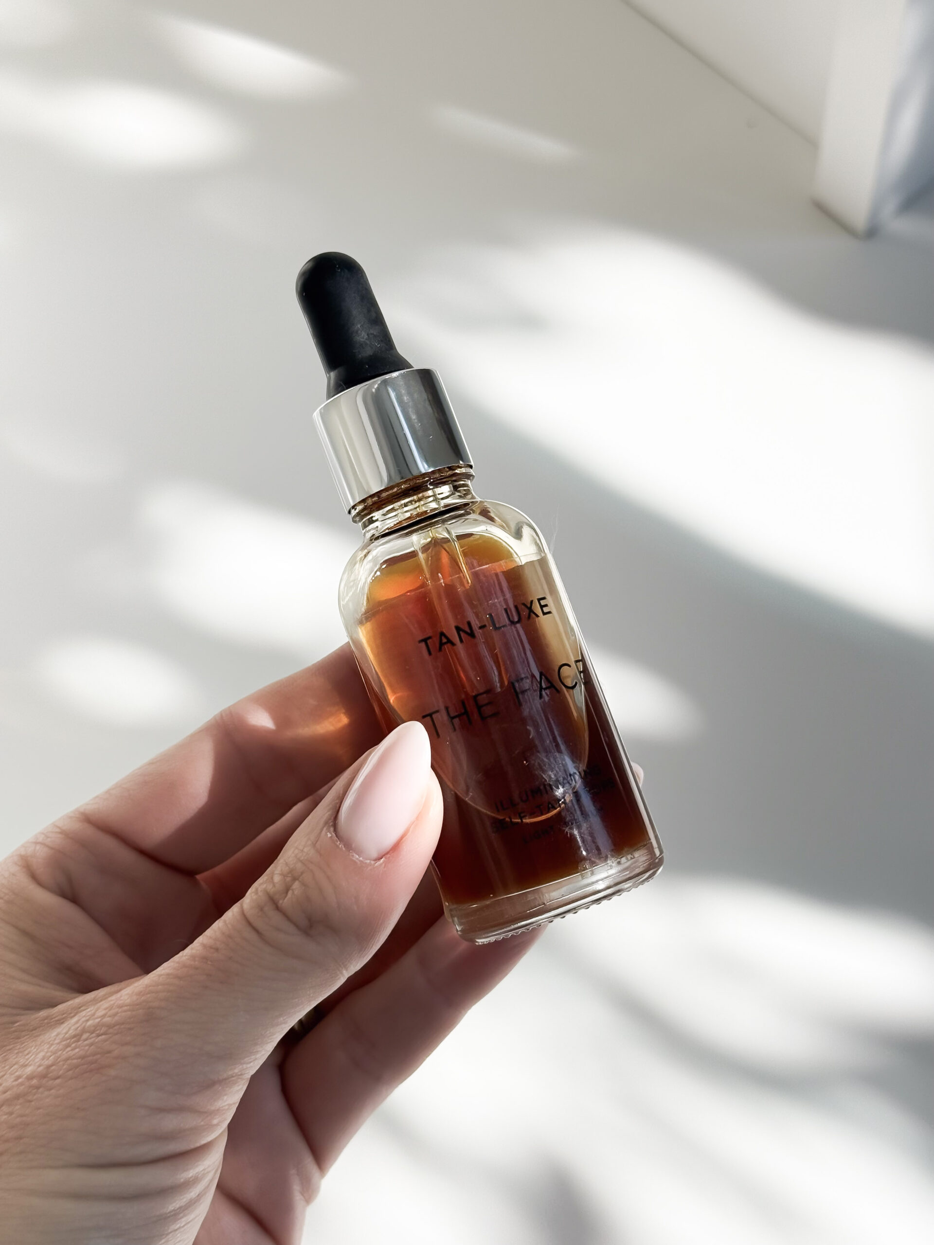 jordyn's summer favorites |  image of a woman holding self-tanning drops by tan luxe