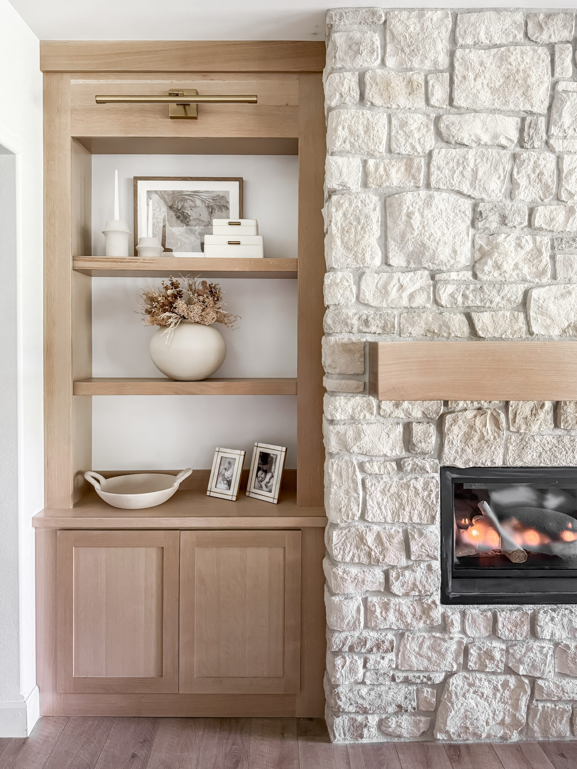 organic modern basement reveal featuring modern lighting, faux florals, frames, home decor