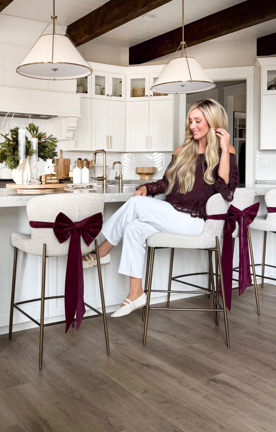 image of woman sitting on bar stools with red bow on the back