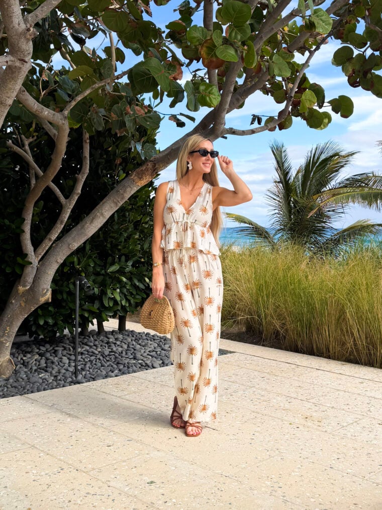 image of woman wearing palm tree two piece set