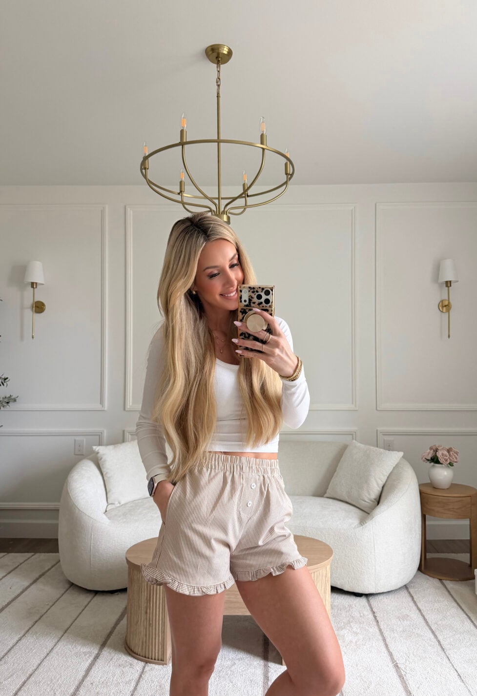 woman wearing long sleeve and ruffle shorts
