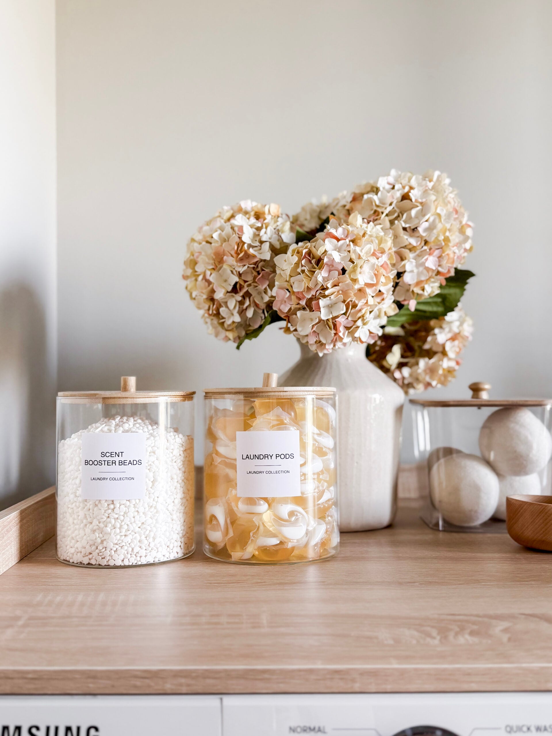faux hydrangeas in a vase in a laundry room
