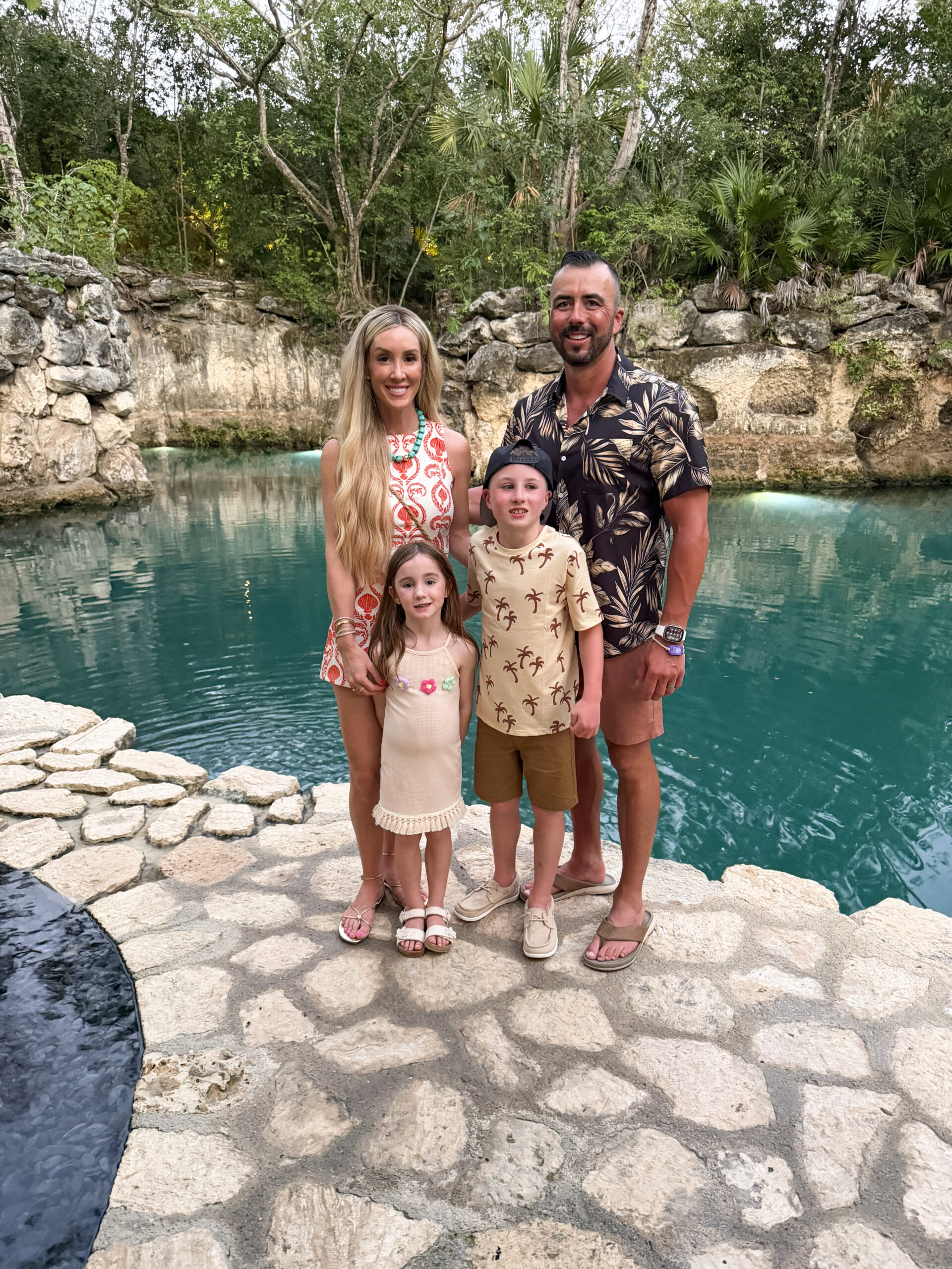 family standing in front of pool