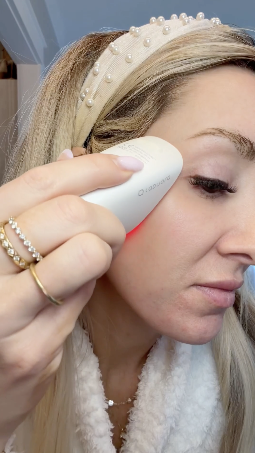 woman with red light facial device