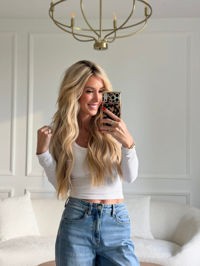 woman wearing white top and blue jeans