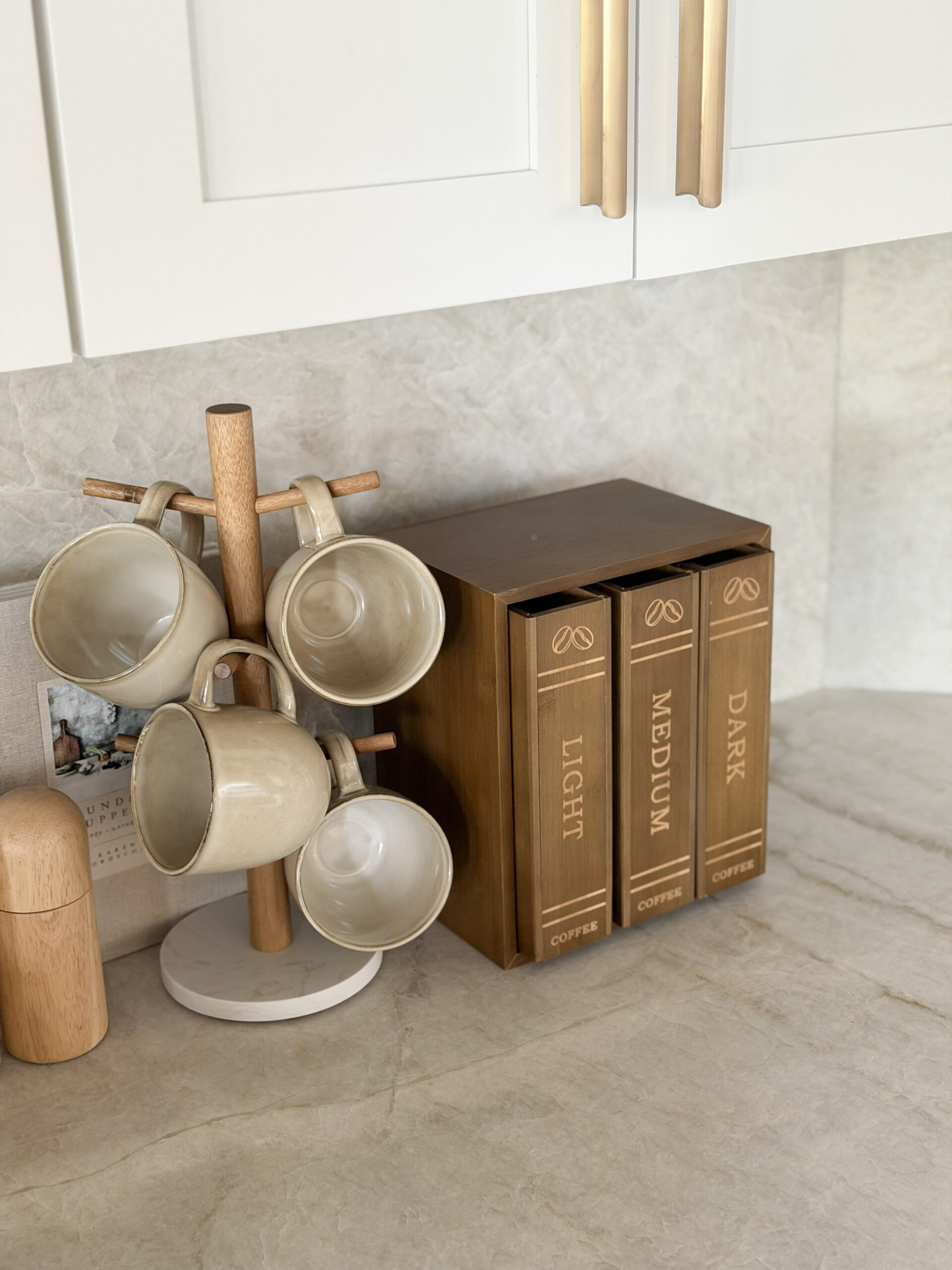 coffee mugs on stand and coffee pod holder on countertop