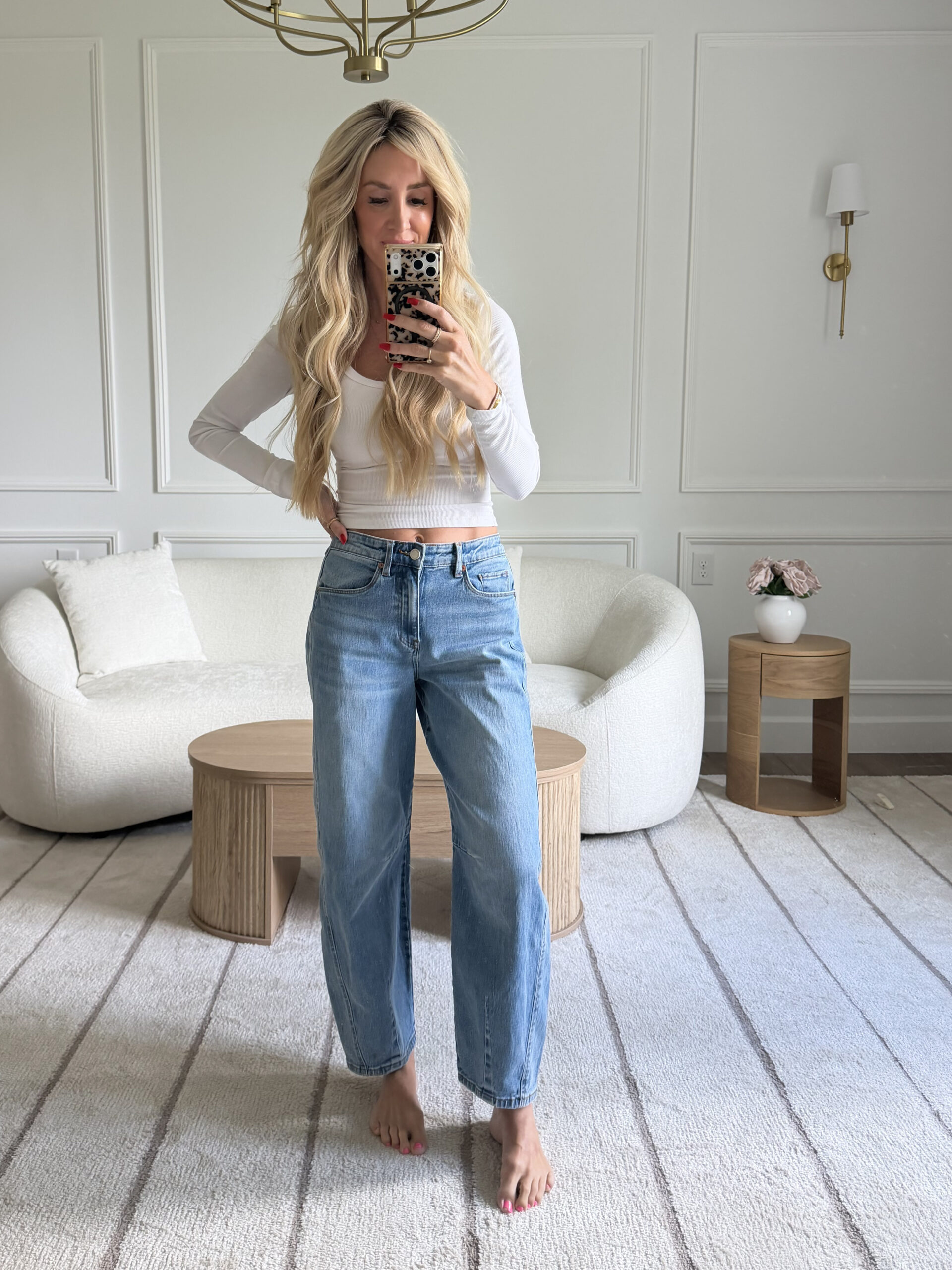 woman wearing white top and blue jeans