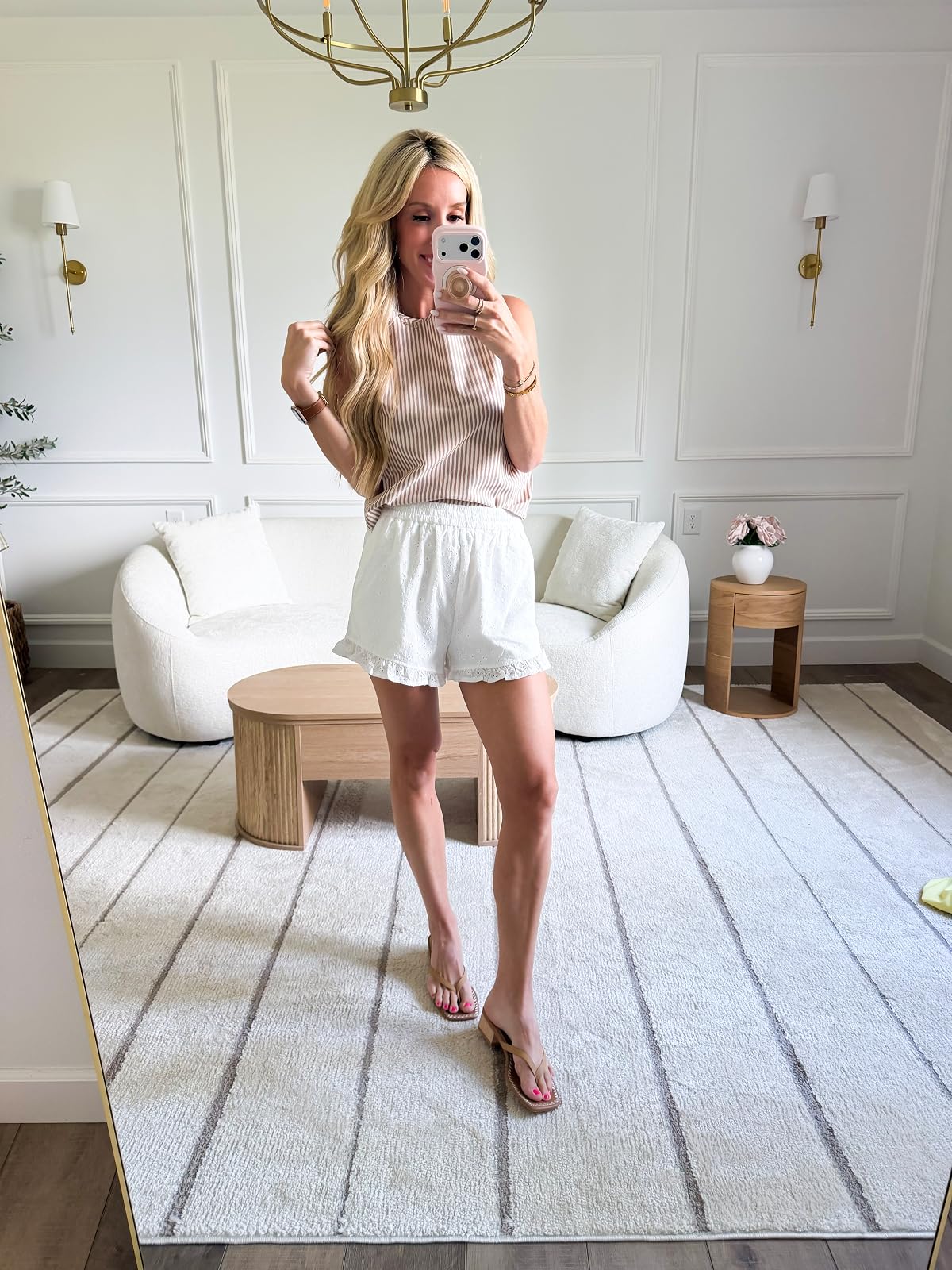woman in striped tank and white shorts