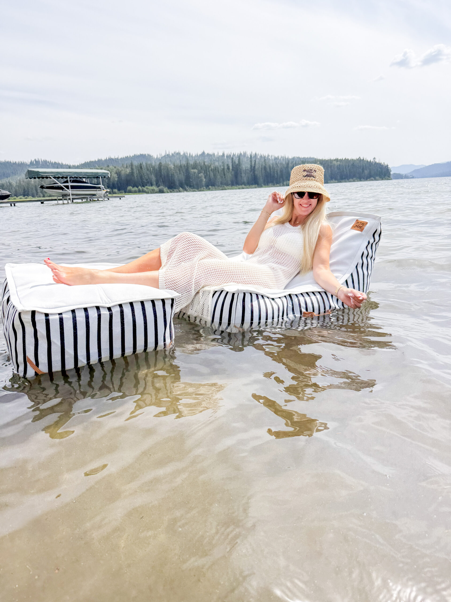 woman sitting on floating lounge chair on water