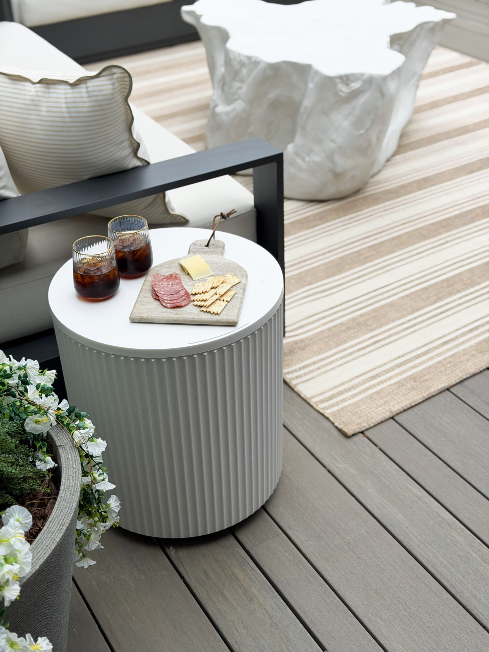outdoor side table with drinks and snacks on top