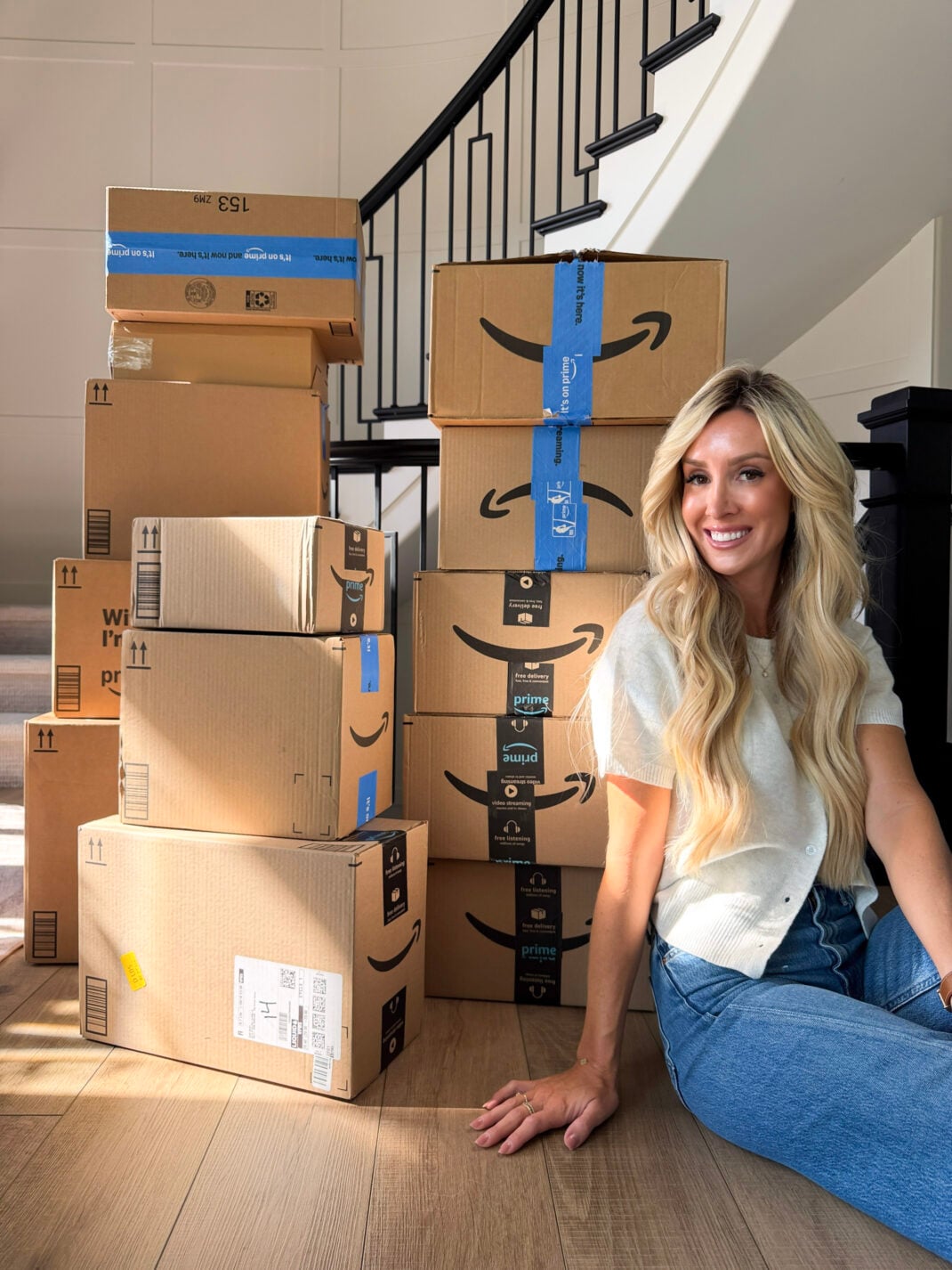 woman sitting in front of prime boxes